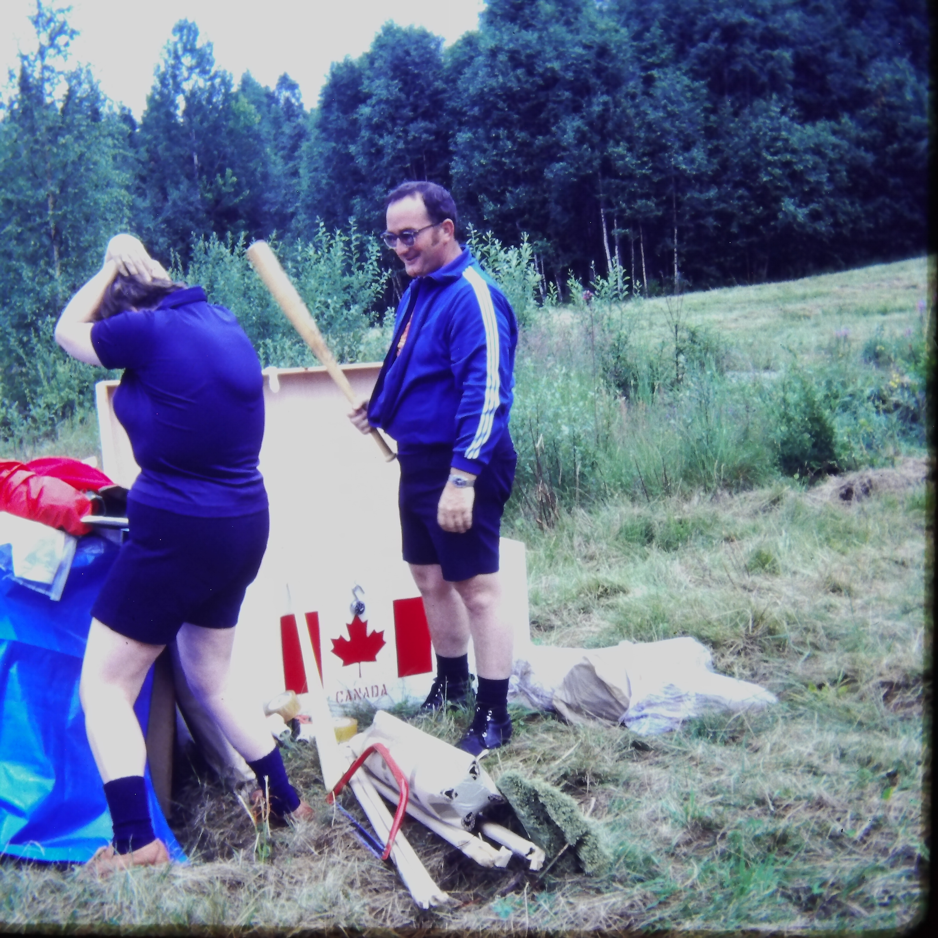 Unpacking tents, Shirley clowning with Jack Davidson